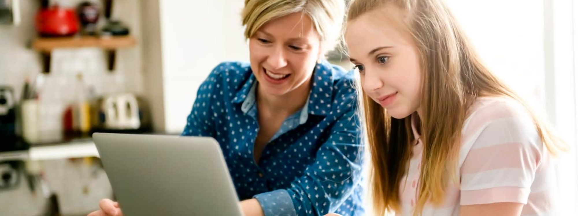 Teen and mom on computer